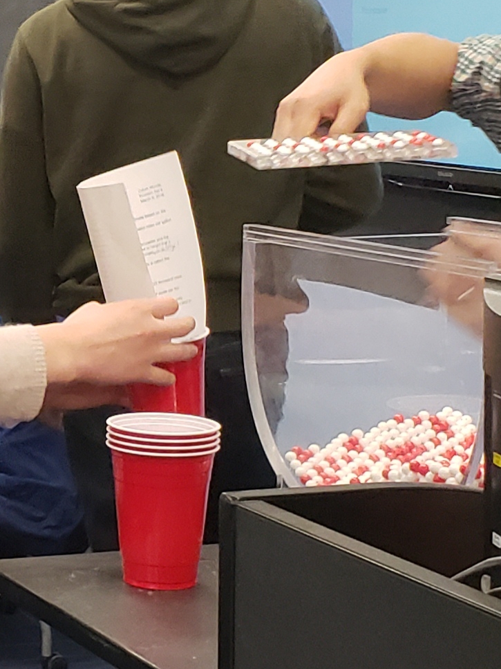 Students taking samples from the bowl.