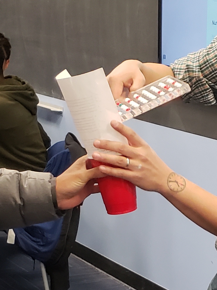 Students recording the number of red balls in their sample.